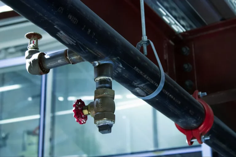 Close-up of a gas pipe with a valve and fittings, illustrating gas piping components.